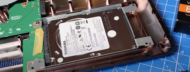 Removing the hard drive of a Toshiba laptop.